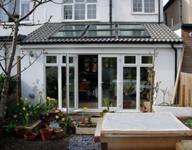 Exterior view of room extension with glass doors to the garden