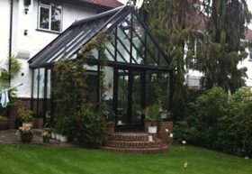 Black framed conservatory with pitched glass roof